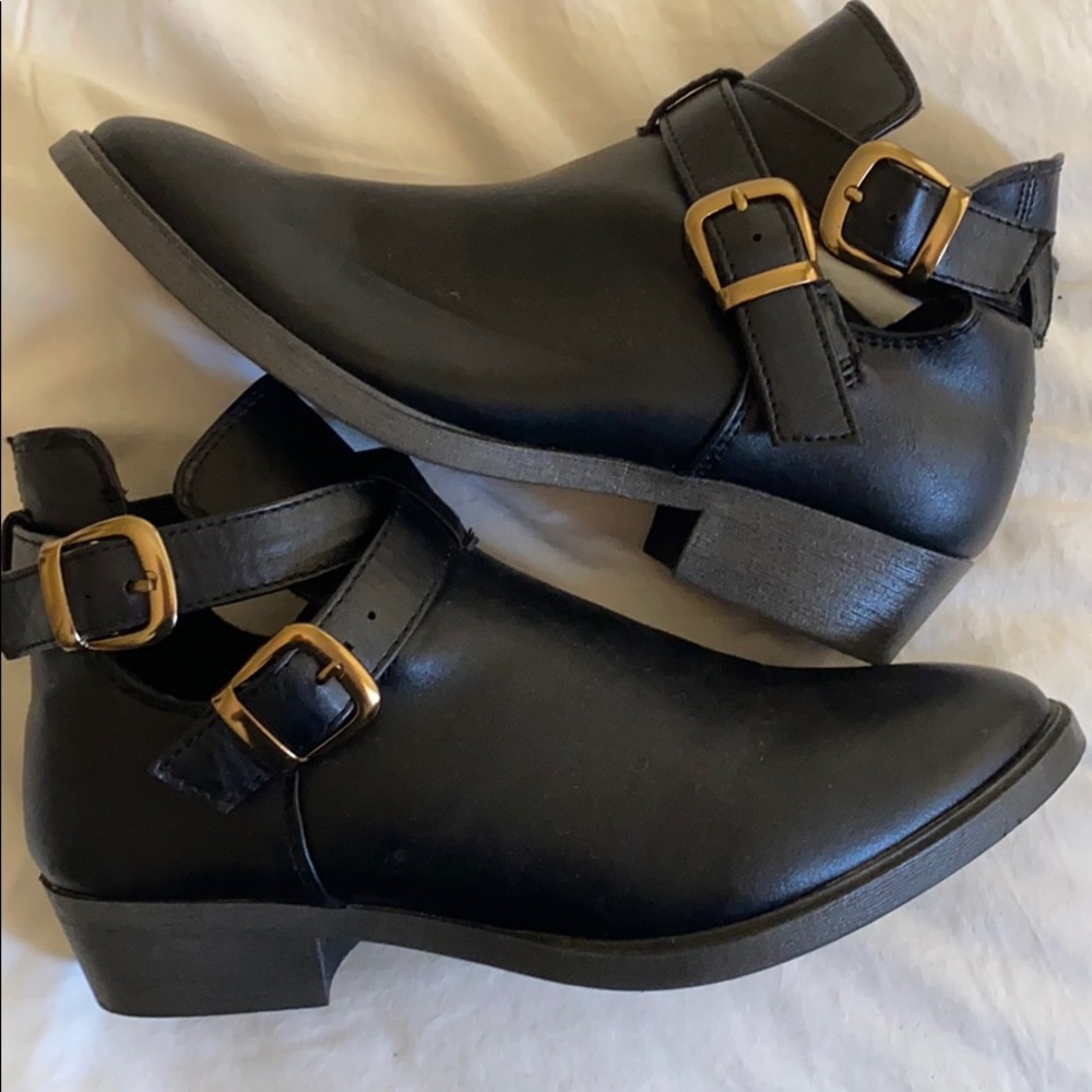 Black ankle booties with gold buckles